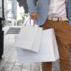 Shopaholic man walking on commercial street with shopping bags Shopaholic man walking on commercial street with a lot of shopping bags